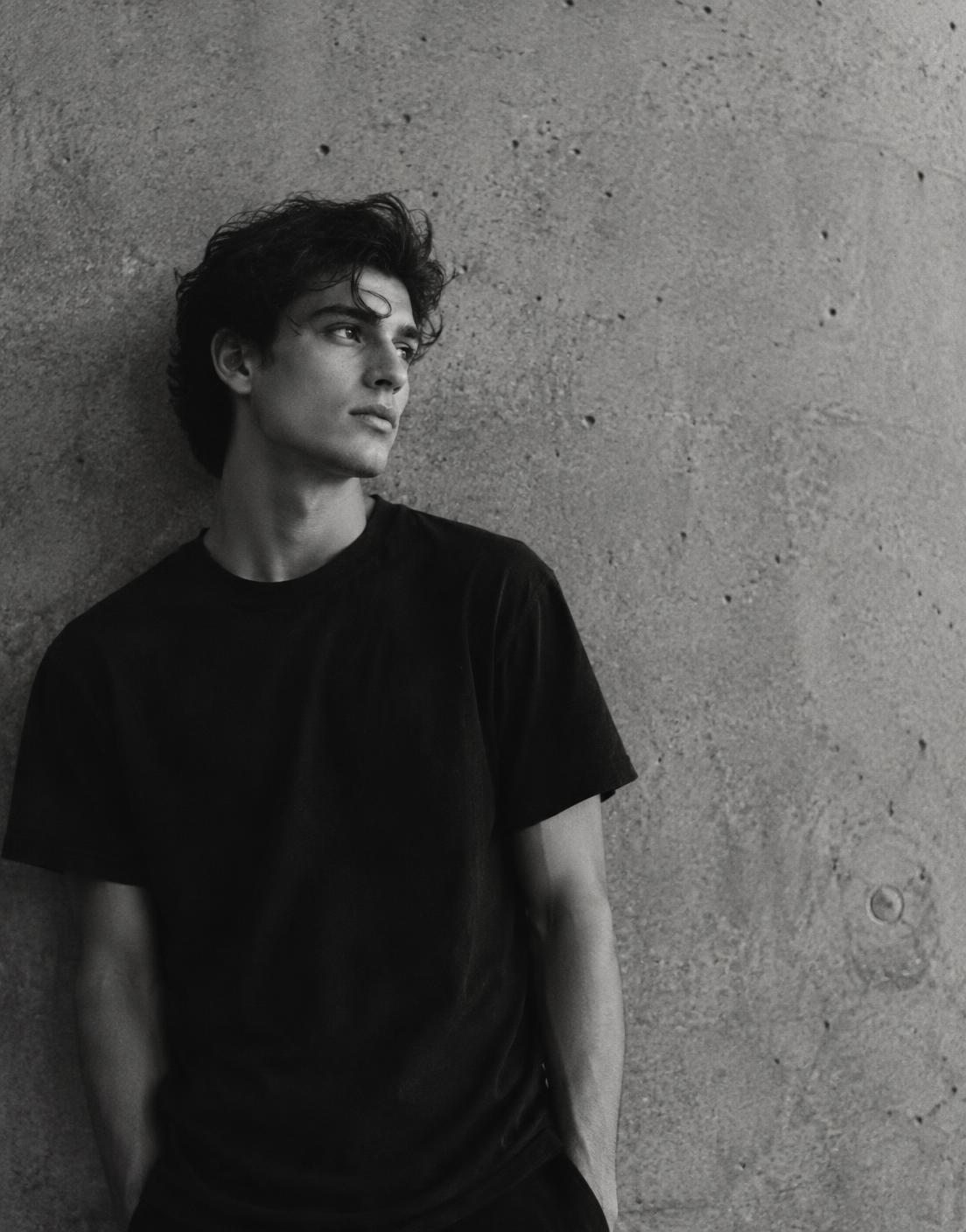 Portrait against raw concrete representing quiet personal progress
